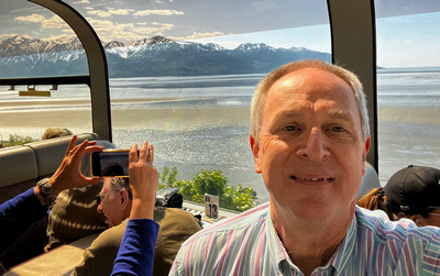 Joe in the dome car with mudflats, inlet and mountains