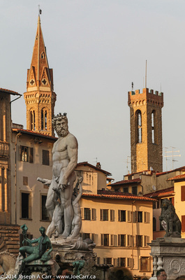 Poseidon statue with towers behind