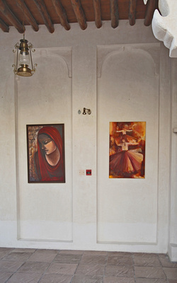 Two paintings hung on a wall