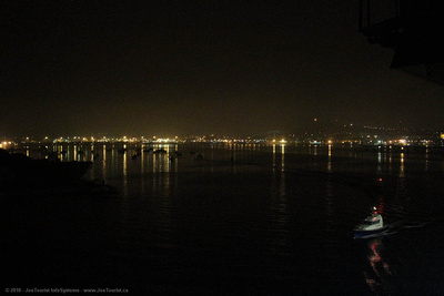 Pilot boat escorts Volendam through Noumea harbour during night departure