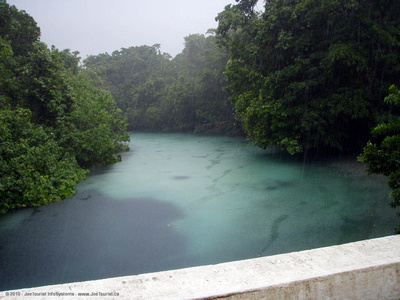 Blue-coloured river in the rain