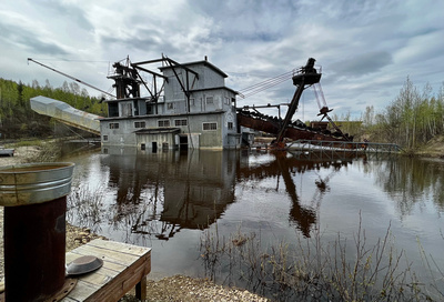 The dredge, partly submerged in flood waters