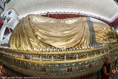 The Reclining Buddha with a monk & candles