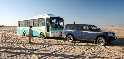 Our bus stuck in the sand at Eclipse Camp, being pulled out