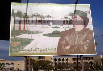 Giant Mu'ammar Gaddafi sign, Garyounis Resort behind