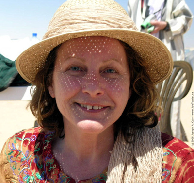 Eclipsed Sun images projected onto Lucy Winnicki's face through her straw hat