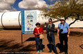 Diane Bell, Matt Watson and Reg Dunkley in front of the Space Shuttle booster and Pima Air Museum sign