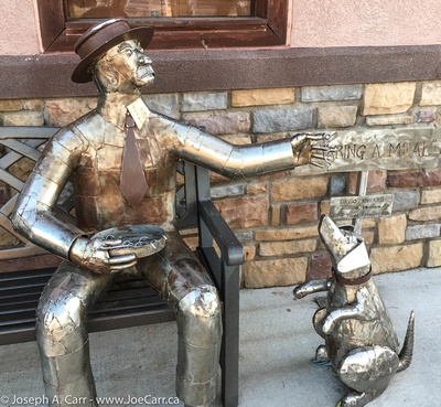Street art: 'Sharing A Meal' a man and his dog, by David Voisard