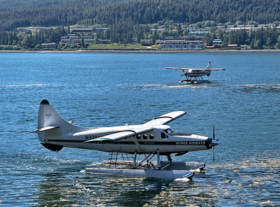 Two Wings Airways float planes approaching the dock