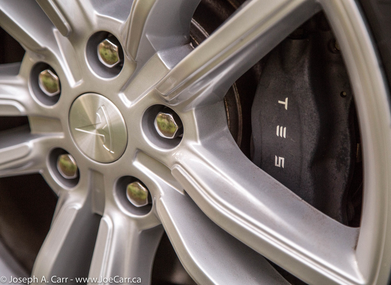 Tesla T logo on the wheel centre cap and black Tesla brake