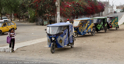 A row of Tuktuck motorcycle taxis