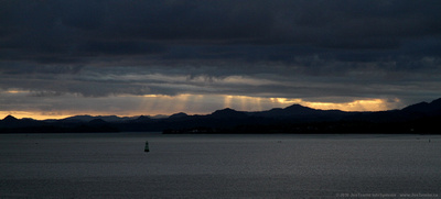 Crepuscular rays near sunset over the outer harbour