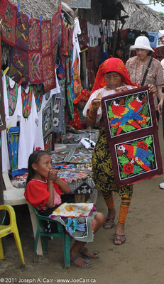 Cuna woman in traditional dress with Molas and young girl