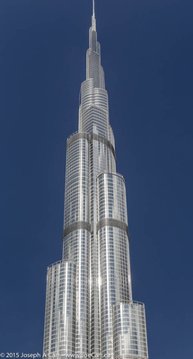 The top of the Burj Khalifa against a blue sky