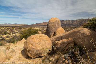 Boulders, ranch land and mountains