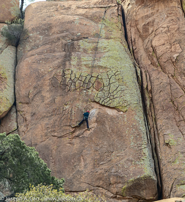 Rock climber on a massive rock wall