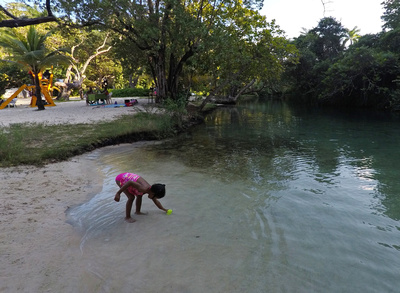 Jamaican girl playing in the freshwater stream