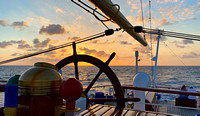 Sunset over the Caribbean framed by the stern wheel