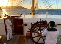 The helmsman on the wheel as Captain Sergey Tunikov directs from the bridge