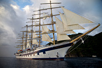 The Royal Clipper weighing anchor & under sail as she departs Soufriere at sunset