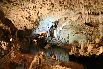 Staligmites, staligtites and a stream in a cave gallery