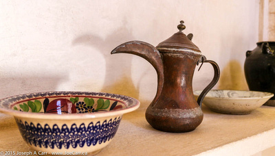A decorated bowl and a jug with a big spout
