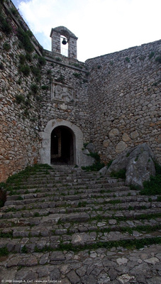 Huge steps leading to a gate and bell tower