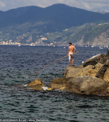 Fishing on the rock seawall at Riomaggiore