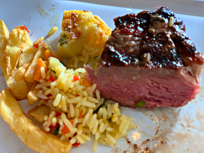Sirloin steak with baked cheese, rice and french fries