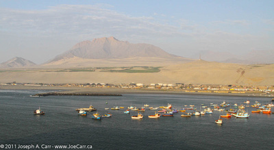 Fish boats with mountain & desert behind