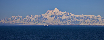Cruise ship close to shore ice dominated by Mt. St. Elias behind