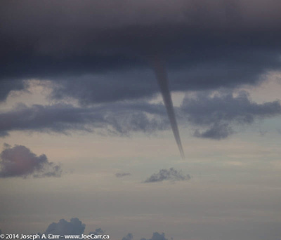 Funnel cloud forming from a thunder cloud