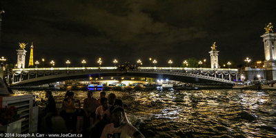 Pont de Concorde at night with the Eiffel Tower in the distance