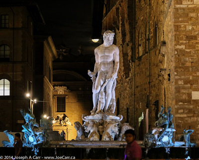 Poseiden statue at night
