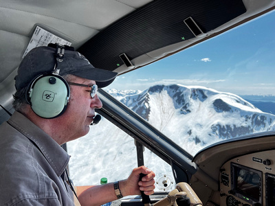 Our pilot with snow-capped mountains