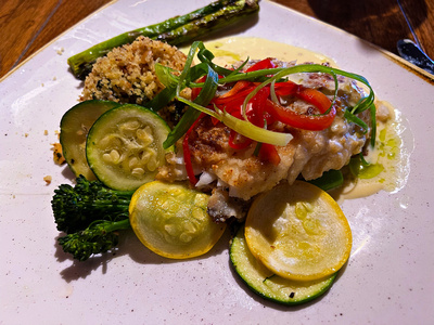 Cashew crusted rock fish with cous cous and vegetables