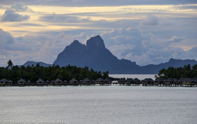 A resort on the west shore of Taha'a with Bora Bora looming behind