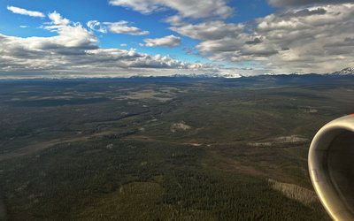 Klondike River below with snow-capped mountains in the distance