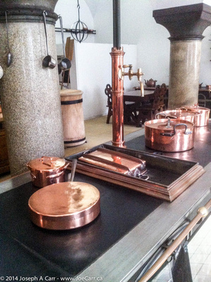 Copper pots on a stove in the castle kitchen