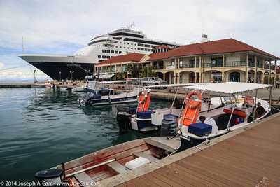 Boats for hire in boat basin with Statendam docked behind Visitors Centre