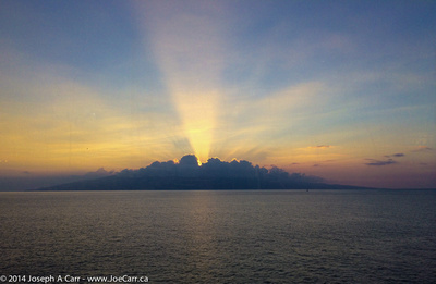 Anti-Crepuscular Rays from a sunset behind clouds on Lanai