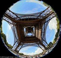 The whole Eiffel Tower viewed through a fisheye lens from underneath