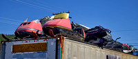 Snowmobiles stored on top of a container box
