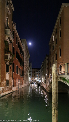 Venetian canal at night and an almost Full Moon