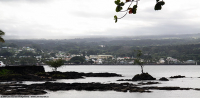 Fisherman on point in Hilo Bay