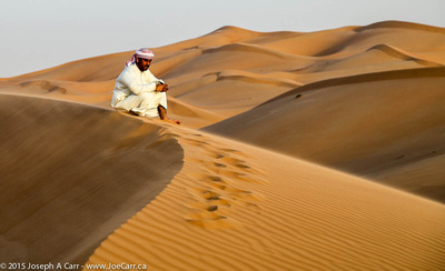 Arab man on a windswept sand dune
