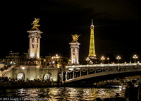 The Eiffel Tower and Pont de la Concorde towers lit at night